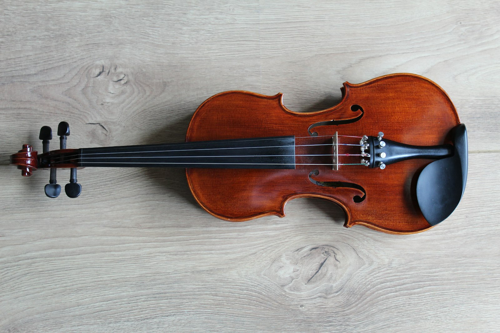 A violin resting on a wooden surface